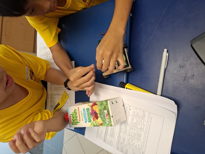 Students building a Solar Bus with a recycled juice carton.